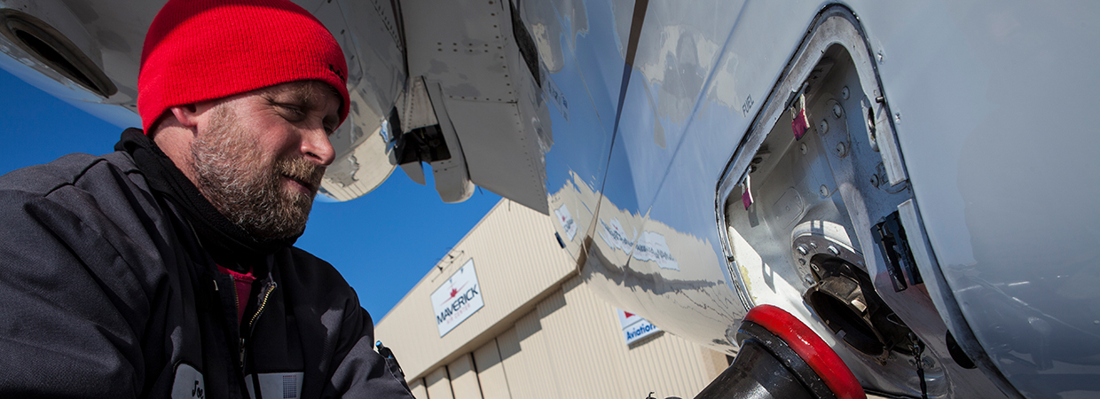 man fueling up plane